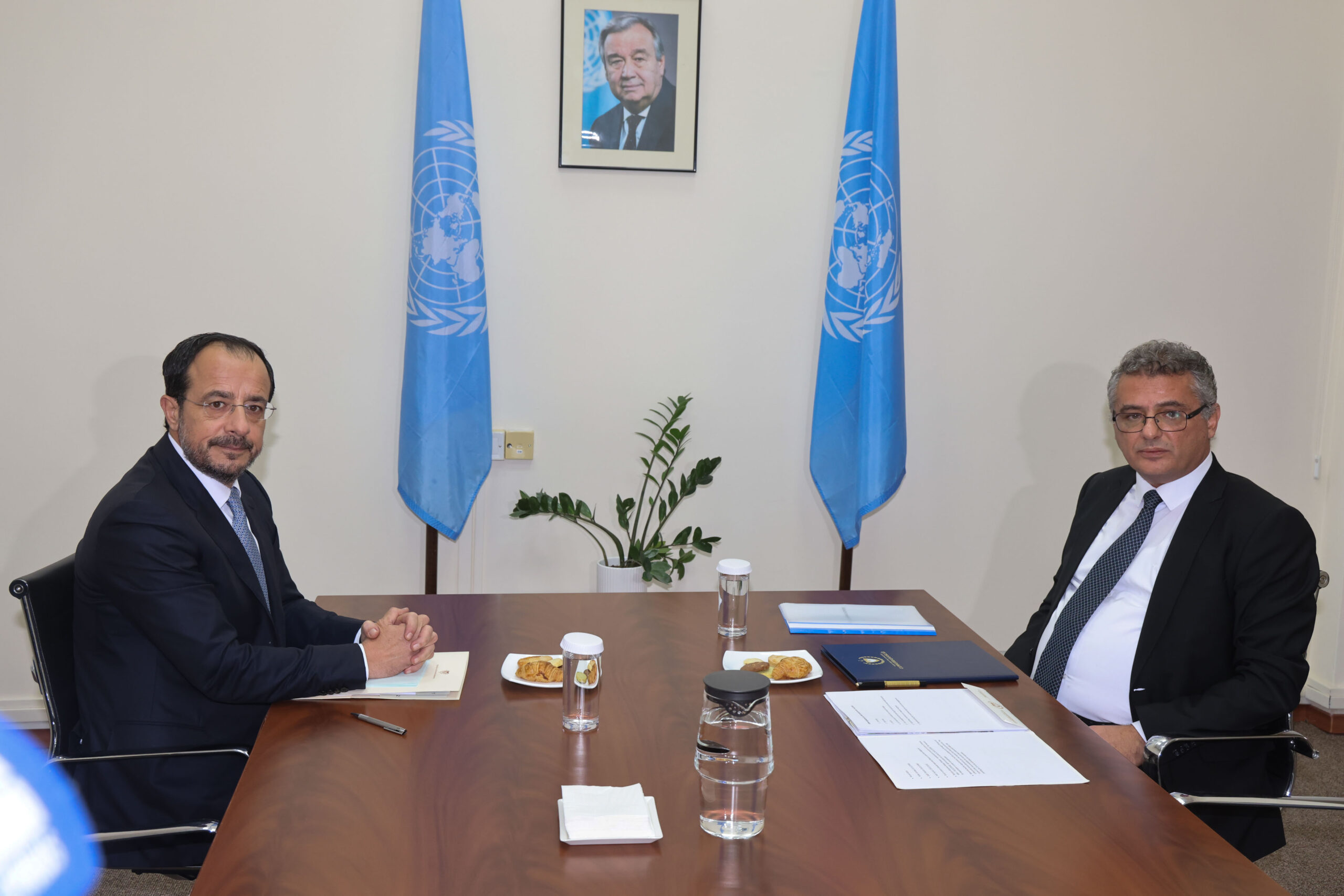 Nicos Christodoulides and Tufan Erhürman sitting at a conference table